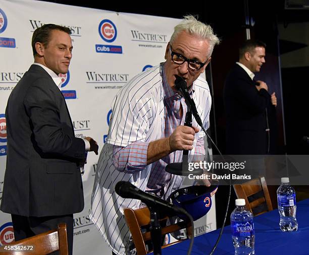 The Chicago Cubs new manager Joe Maddon makes a statement as Chicago Cubs President Theo Epstein and general manager Jed Hoyer look on after a press...