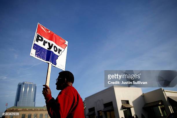 Supporter of U.S. Sen. Mark Pryor holds a sign as people line up for early voting outside of the Pulaski County Regional Building on November 3, 2014...