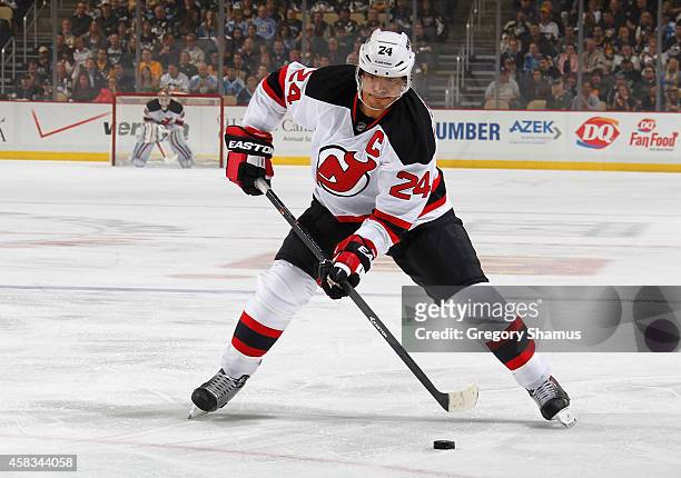 Bryce Salvador of the New Jersey Devils moves the puck against the Pittsburgh Penguins at Consol Energy Center on October 28, 2014 in Pittsburgh,...