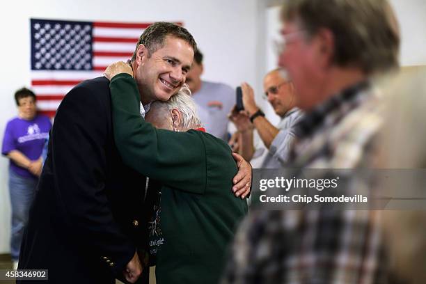 Democratic U.S. Senate candidate Rep. Bruce Braley hugs volunteer Pat Halferty during a campaign stop at the Lynn Count Democratic Headquarters...