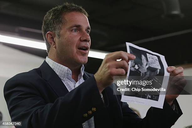 While encouraging volunteers not to give up, Democratic U.S. Senate candidate Rep. Bruce Braley holds a copy of the photograph of President Harry...