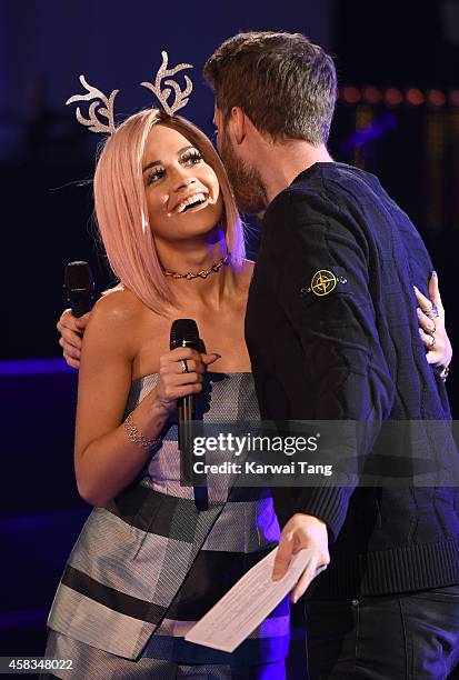 Rita Ora and Rick Edwards attend the switching on of the Westfield London Christmas Lights at Westfield London on November 3, 2014 in London, England.