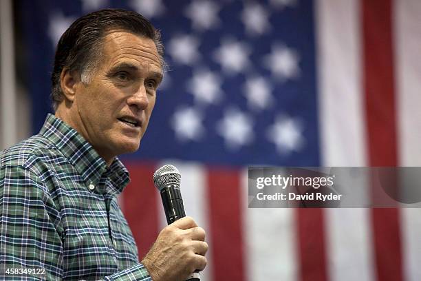 Former Massachusetts Gov. Mitt Romney addresses the crowd during a rally for Republican Senate candidate Dan Sullivan at a PenAir airplane hangar on...
