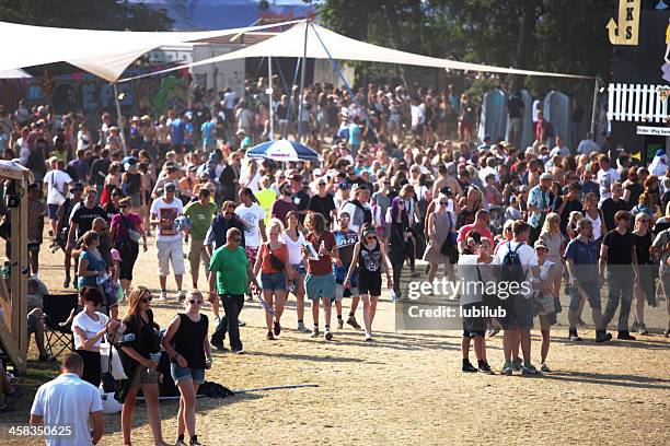 people walking around on roskilde festivalsquare - roskilde fjord stock pictures, royalty-free photos & images