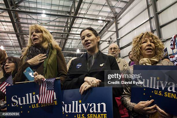 Supporters of Republican Senate candidate Dan Sullivan recite the Pledge of Allegiance during a rally at a PenAir airplane hangar on November 3, 2014...