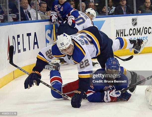 Derick Brassard of the New York Rangers is hit by Kevin Shattenkirk of the St. Louis Blues during the second period at Madison Square Garden on...