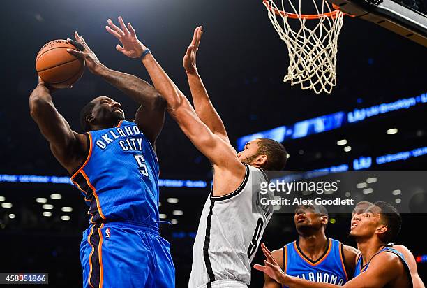Kendrick Perkins of the Oklahoma City Thunder shoots over Jerome Jordan of the Brooklyn Nets in the first half at the Barclays Center on November 3,...