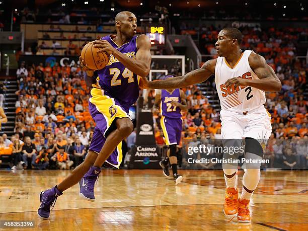 Kobe Bryant of the Los Angeles Lakers drives the ball past Eric Bledsoe of the Phoenix Suns during the NBA game at US Airways Center on October 29,...