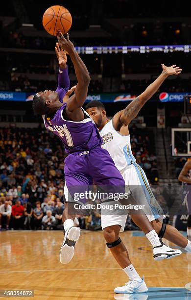 Darren Collison of the Sacramento Kings is fouled by Alonzo Gee of the Denver Nuggets at Pepsi Center on November 3, 2014 in Denver, Colorado. NOTE...