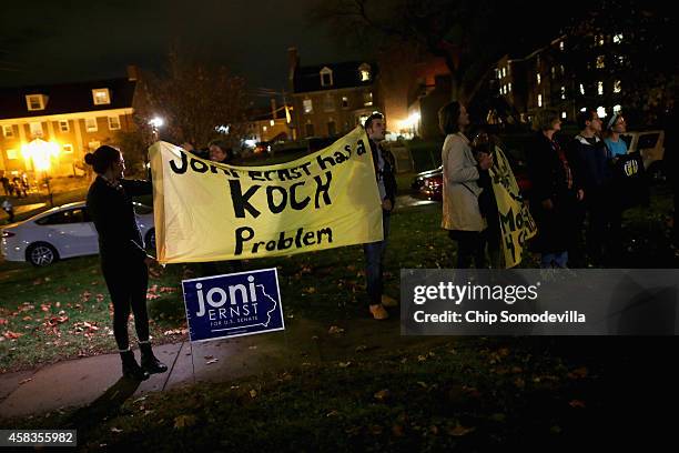 People demonstrate against Republican U.S. Senate candidate Joni Ernst as she addressed supporters at the Alpha Gamma Rho fraternity house on the...