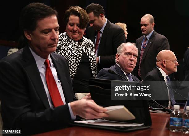 Director James Comey, Central Intelligence Agency Director John Brennan, and Director of National Intelligence James Clapper wait for the beginning...