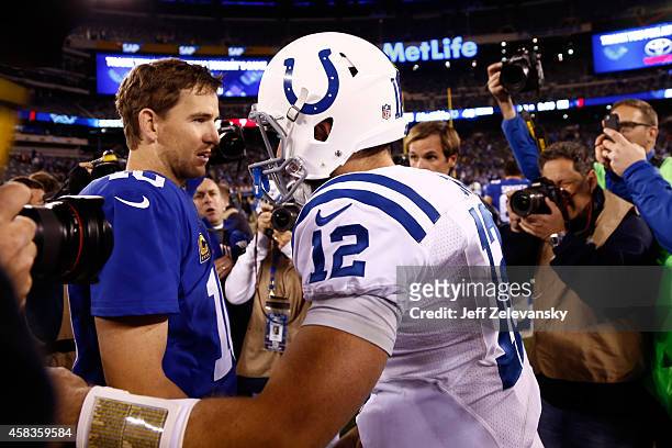 Eli Manning of the New York Giants shakes hands with Andrew Luck of the Indianapolis Colts after their game at MetLife Stadium on November 3, 2014 in...
