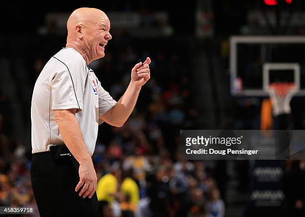 Referee Joey Crawford shares a lighter moment as he oversees the action between the Sacramento Kings and the Denver Nuggets at Pepsi Center on...