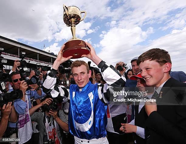 Jockey Ryan Moore celebrates with the trophy after winning on Protectionist in race 7 the Emirates Melbourne Cup on Melbourne Cup Day at Flemington...