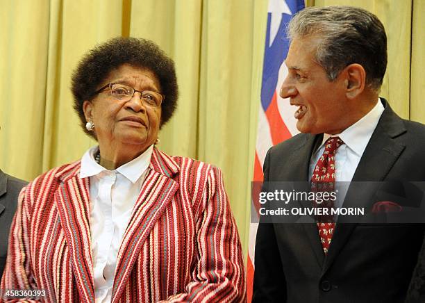 Liberia President Ellen Johnson Sirleaf speaks with UN Special Representative Farid Zarif during a ceremony to mark the security handover from UN...