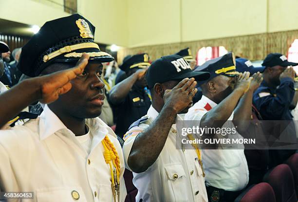 Police heads salute during a ceremony to mark the security handover from UN troops to Liberian forces on July 1, 2016 in Monrovia. Top Liberian and...