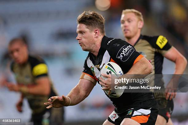 Chris Lawrence of the Tigers makes a break during the round 17 NRL match between the Wests Tigers and the Penrith Panthers at ANZ Stadium on July 2,...