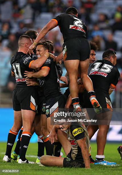 Tigers players celebrate a try during the round 17 NRL match between the Wests Tigers and the Penrith Panthers at ANZ Stadium on July 2, 2016 in...