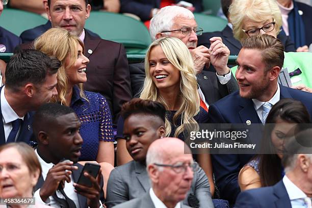 James Anderson, Daniella Anderson, Stuart Broad and Bealey Mitchell Broad in conversation in centre court on day six of the Wimbledon Lawn Tennis...