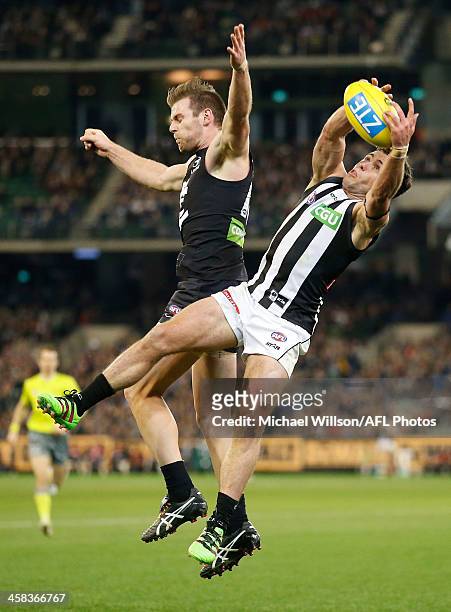 Jarryd Blair of the Magpies attempts to mark over Sam Docherty of the Blues during the 2016 AFL Round 15 match between the Carlton Blues and the...