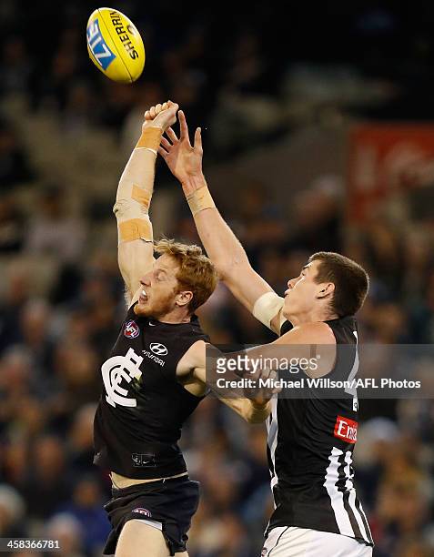 Mason Cox of the Magpies and Andrew Phillips of the Blues compete for the ball during the 2016 AFL Round 15 match between the Carlton Blues and the...