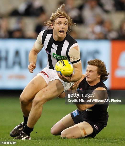 Ben Sinclair of the Magpies is tackled by Liam Sumner of the Blues during the 2016 AFL Round 15 match between the Carlton Blues and the Collingwood...