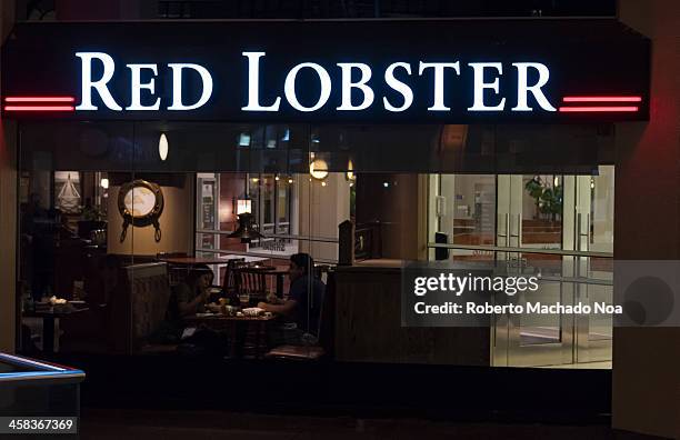 Red Lobster's restaurant entrance sign light up at night. The restaurant is know for its delicious sea food. Red Lobster is an American casual dining...