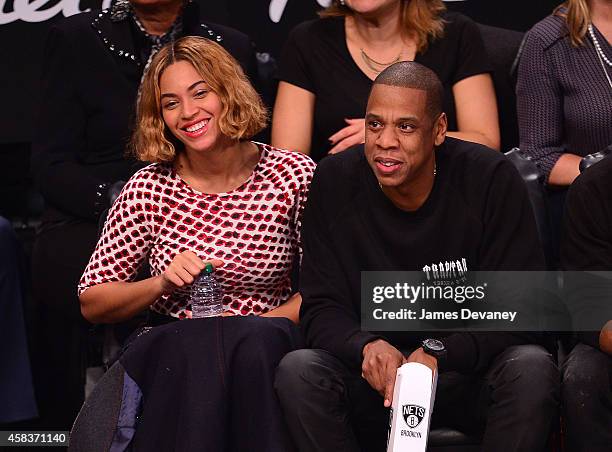 Beyonce Knowles and Jay-Z attend the Oklahoma City Thunder vs Brooklyn Nets game at Barclays Center on November 3, 2014 in the Brooklyn borough of...