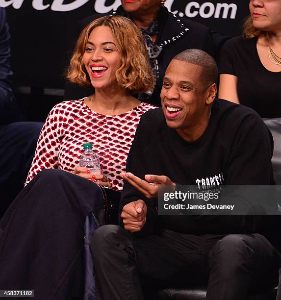 Beyonce Knowles and Jay-Z attend the Oklahoma City Thunder vs Brooklyn Nets game at Barclays Center on November 3, 2014 in the Brooklyn borough of...