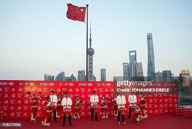 Golfers Justin Rose of England, Rickie Fowler of the US, Adam Scott of Australia, Martin Kaymer of Germany and Bubba Watson of the US wear Chinese...