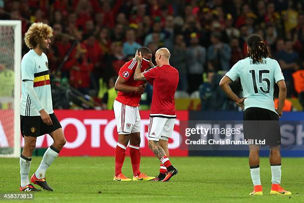 Ashley Williams of Wales is congratulated by team-mate David Cotterill at full-time following the UEFA Euro 2016 Quarter Final match between Wales...