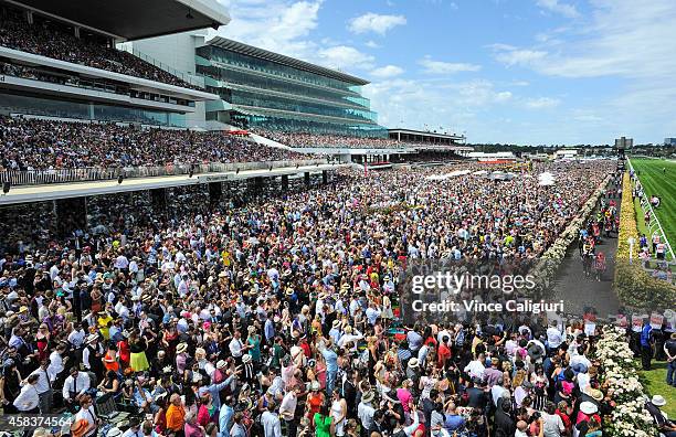 General view of crowds as the field makes its way to the start of Race 7, the Emirates Melbourne Cup on Melbourne Cup Day at Flemington Racecourse on...