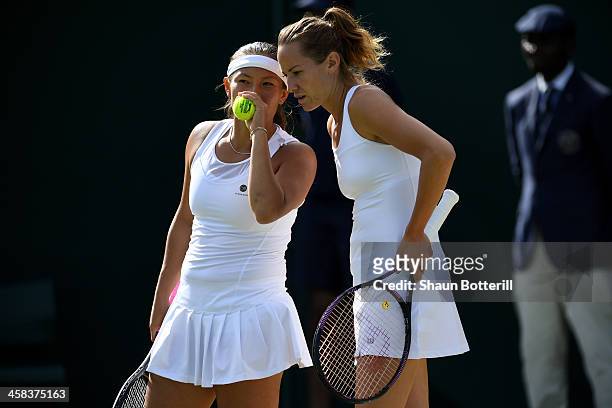 Tara Moore of Great Britain and Conny Perrin of Switzerland in conversation during the Ladies doubles first round match against Mariana Duque-Mariano...
