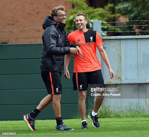 Jurgen Klopp manager of Liverpool with Lucas of Liverpool during the first day back at Training in Melwood Training Ground on July 2, 2016 in...