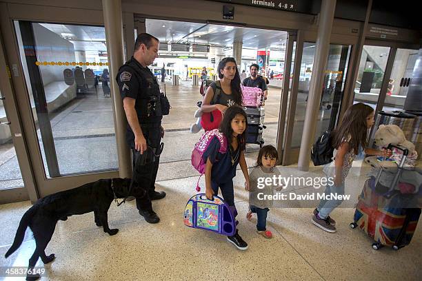 Los Angeles Airport Police officer watches over travelers at Los Angeles International Airport on July 2, 2016 in Los Angeles, California. Security...