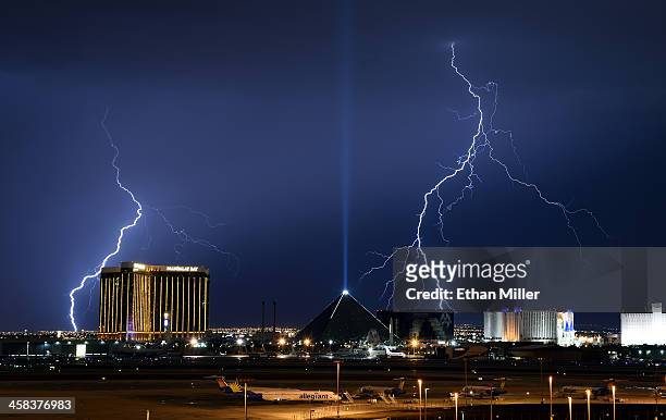 Lightning flashes west of Mandalay Bay Resort and Casino, Luxor Hotel and Casino and Excalibur Hotel & Casino on the Las Vegas Strip on July 2, 2016...