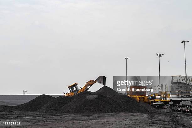 Digger arranges coal stores in the coal yard at the Grootvlei power station, operated by Eskom Holdings SOC Ltd., in Grootvlei, South Africa, on...