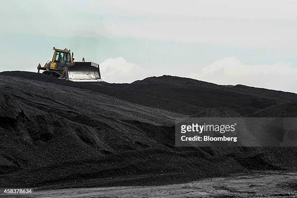 Digger arranges coal stores in the coal yard at the Grootvlei power station, operated by Eskom Holdings SOC Ltd., in Grootvlei, South Africa, on...