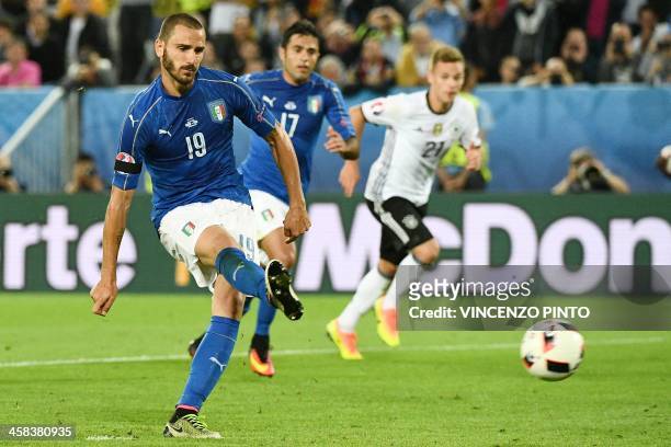 Italy's defender Leonardo Bonucci shoots to score a penalty shot giving Italy their first goal of the match during the Euro 2016 quarter-final...