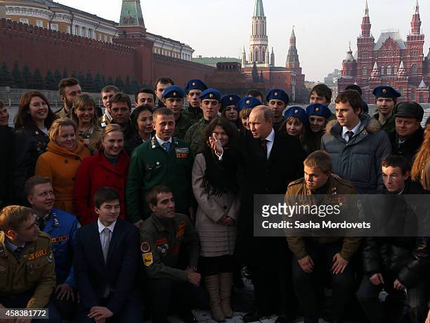 Russian President Vladimir Putin poses for a photo during a ceremony honouring the National Unity Day on Red Square on November 4, 2014 in Moscow,...