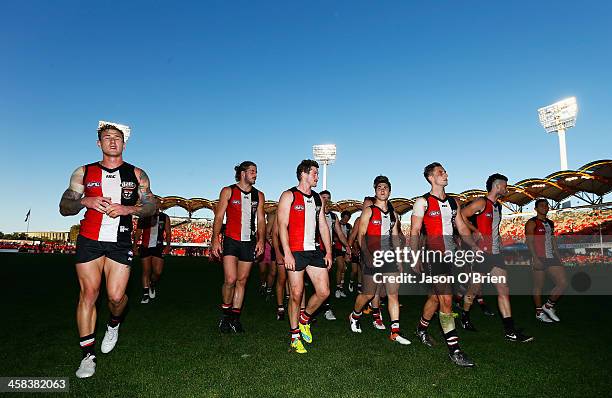 St kilda players leave the field dejected during the round 15 AFL match between the Gold Coast Suns and the St Kilda Saints at Metricon Stadium on...