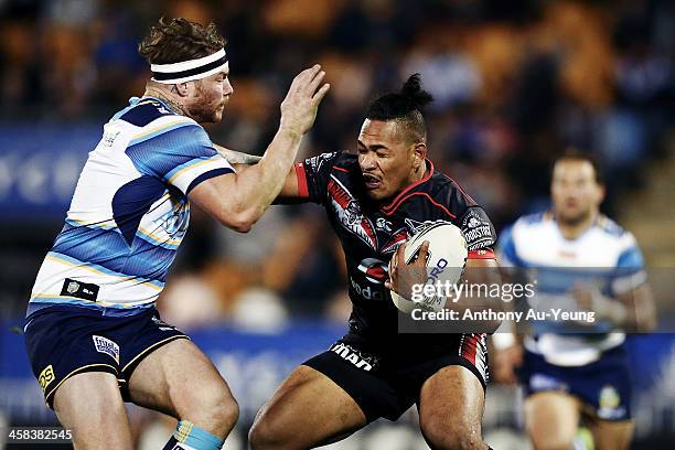 Solomone Kata of the Warriors fends against Chris McQueen of the Titans during the round 17 NRL match between the New Zealand Warriors and the Gold...