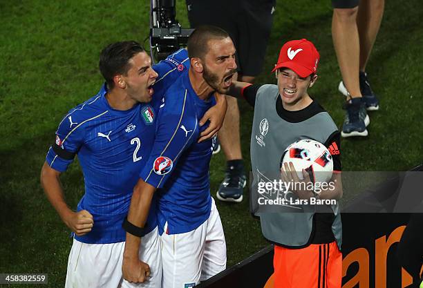 Leonardo Bonucci of Italy celebrates scoring his team's first goal with his team mateMattia De Sciglio and a ball boy during the UEFA EURO 2016...