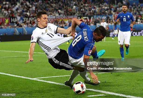 Julian Draxler of Germany and Alessandro Florenzi of Italy compete for the ball during the UEFA EURO 2016 quarter final match between Germany and...