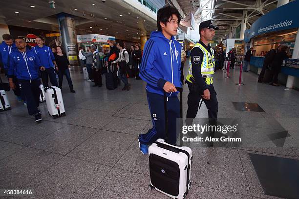 Atsuto Uchida of FC Schalke 04 arrives at Lisbon airport one day ahead of their UEFA Champions League Group G match against Sporting Club de Portugal...