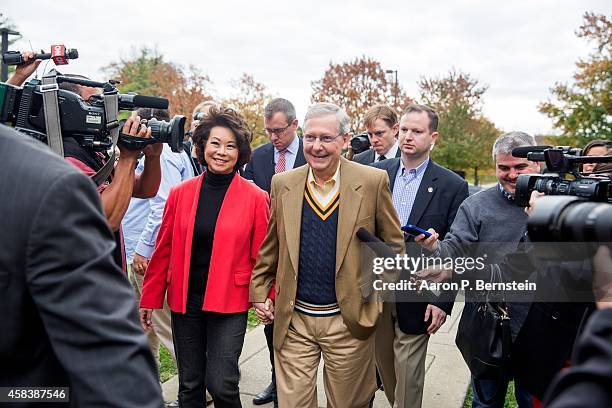 Senate Minority Leader U.S. Sen. Mitch McConnell departs after voting in midterm elections with his wife Elaine Chao at Bellarmine University...