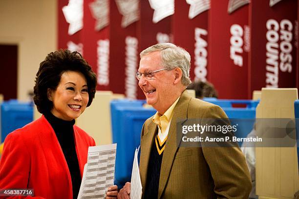 Senate Minority Leader U.S. Sen. Mitch McConnell waits after voting in midterm elections with his wife Elaine Chao at Bellarmine University November...