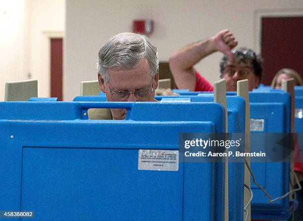 Voter gestures as Senate Minority Leader U.S. Sen. Mitch McConnell votes in the midterm elections at Bellarmine University November 4, 2014 in...