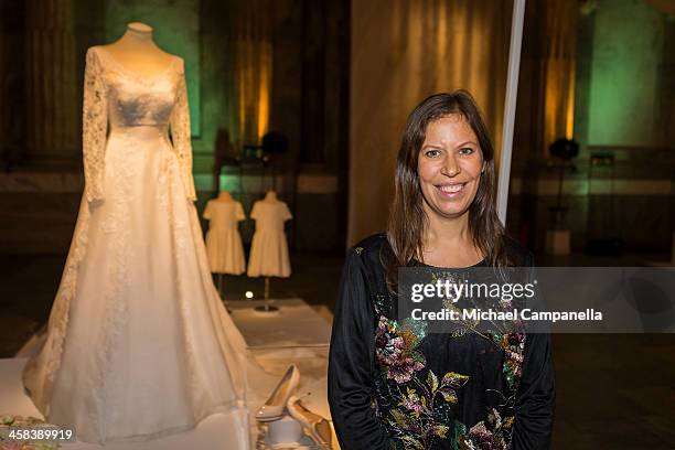 Ida SjÃ¶stedt poses for a portrait in front of the wedding dress she designed for Princess Sofia of Sweden which is on display during an exhibition...