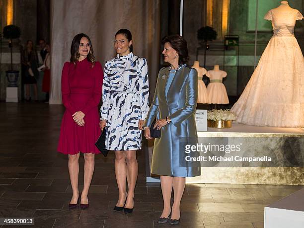 Princess Sofia, Crown Princess Victoria, and Queen Silvia of Sweden attend an exhibition of royal wedding dresses at the Royal Palace on October 17,...
